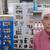 手拭いがトレードマークの長房社長と店内に所狭しと飾られている活動の様子